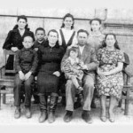 FELSHTIN'S LAST JEWISH FAMILY: Mendel Shvartz and and his wife, Sura Modick, seated, far right. Polina is sitting on Mendel's lap. Polina's sister, Zoya, is standing behind Mendel and Sura. To the left of Mendel is Polina's aunt, Chaika, with her four children, Effin, Sonya, Sergey, and Raisa. Photo 1949. They lived in Gvardeyskoye (formerly Felshtin) until 1970